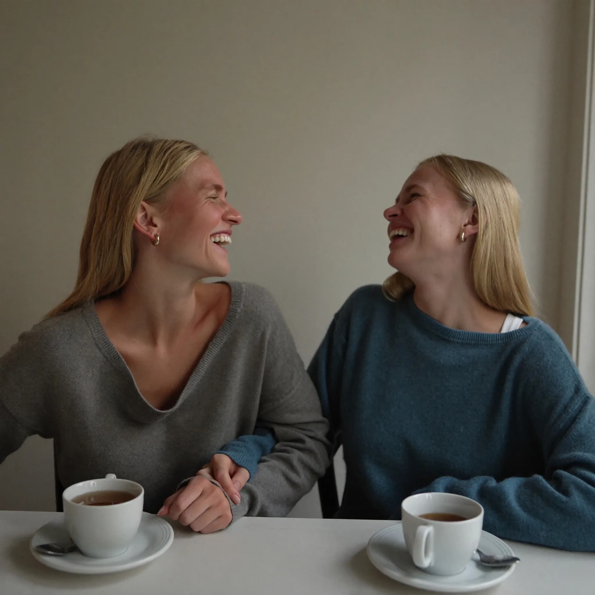 Two women talking warmly at a community session