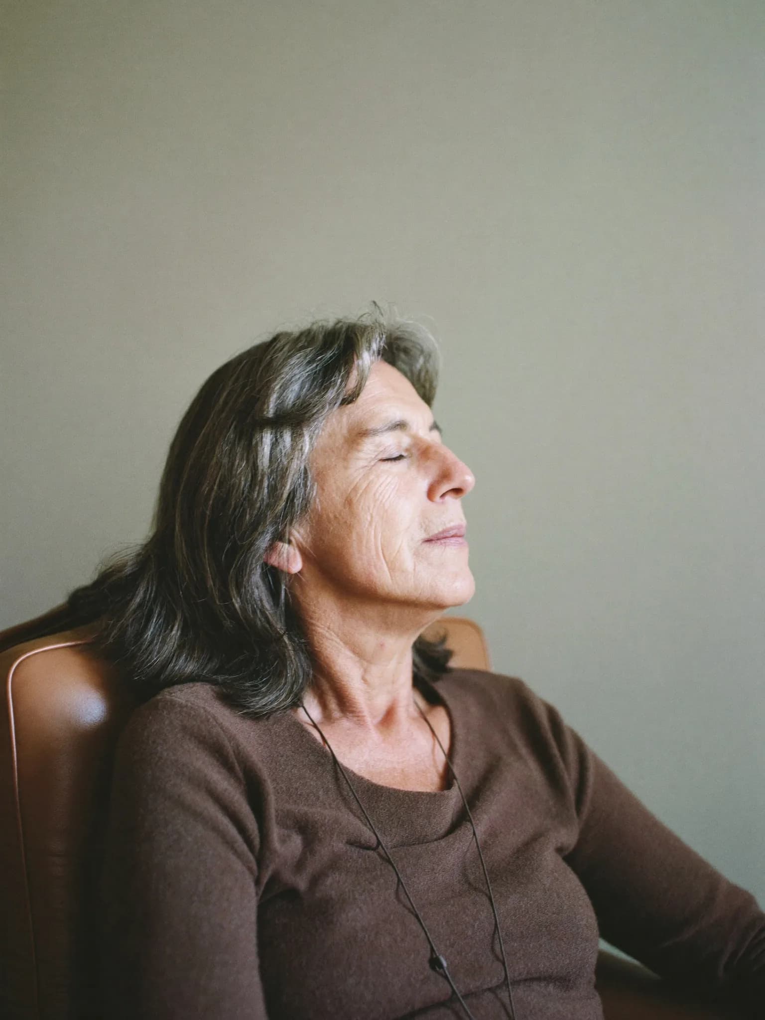 A woman sitting calmly during a wellbeing session