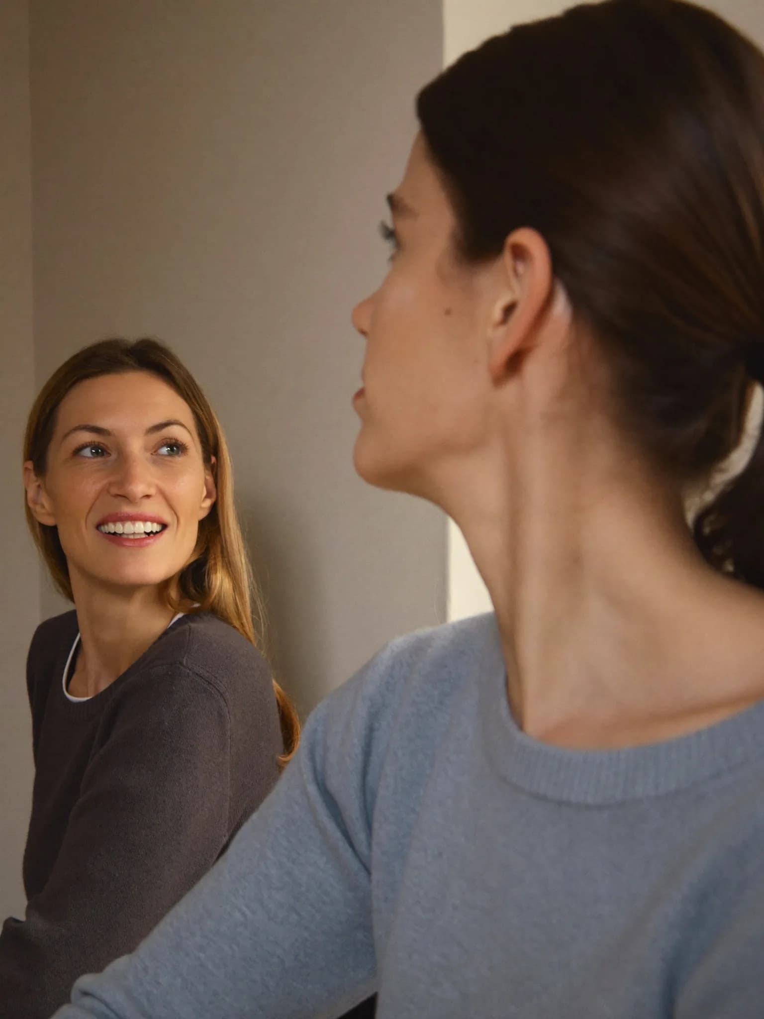 A woman listening attentively to a friend at a community session