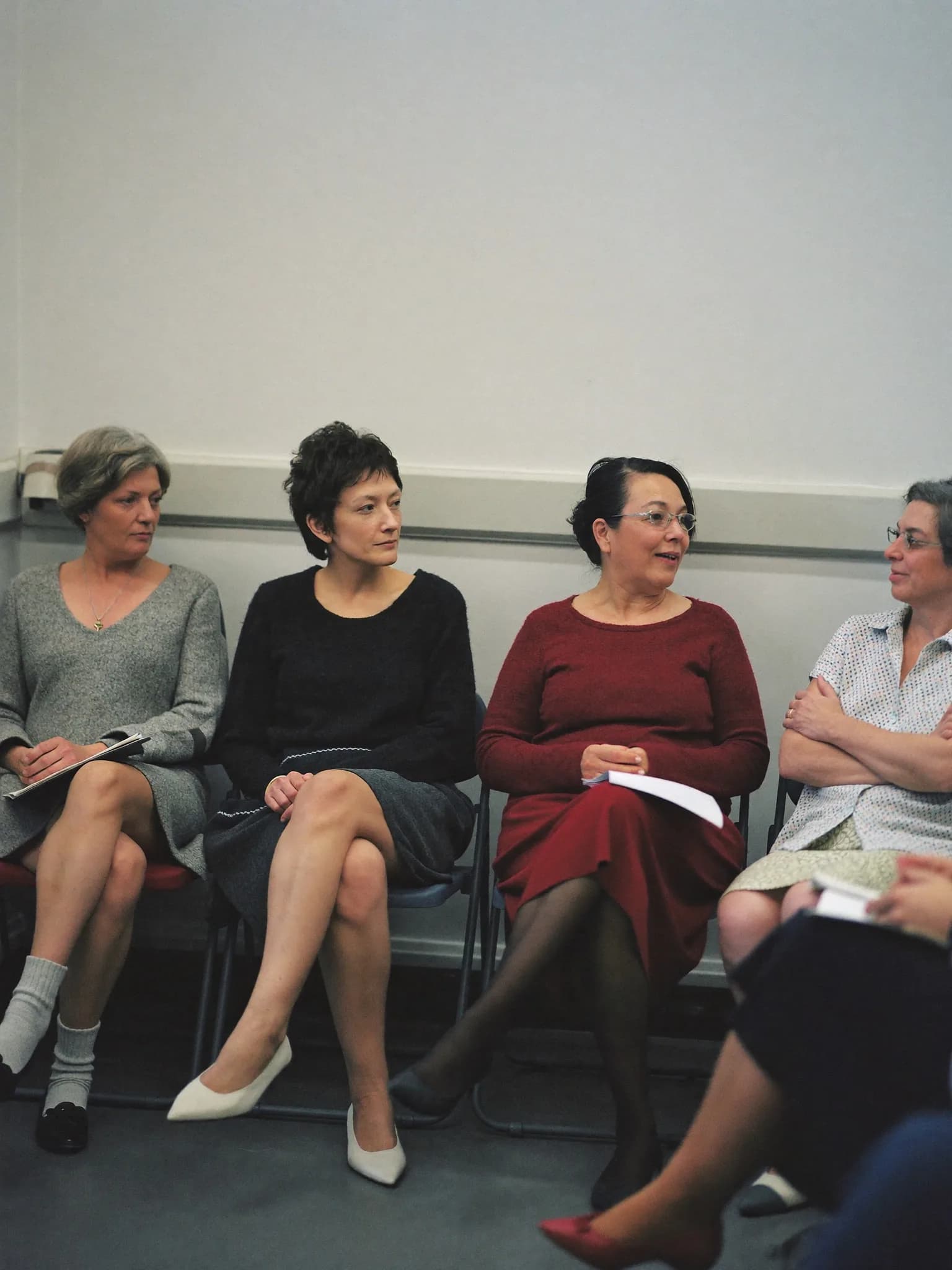 A small circle of women talking during a wellbeing session