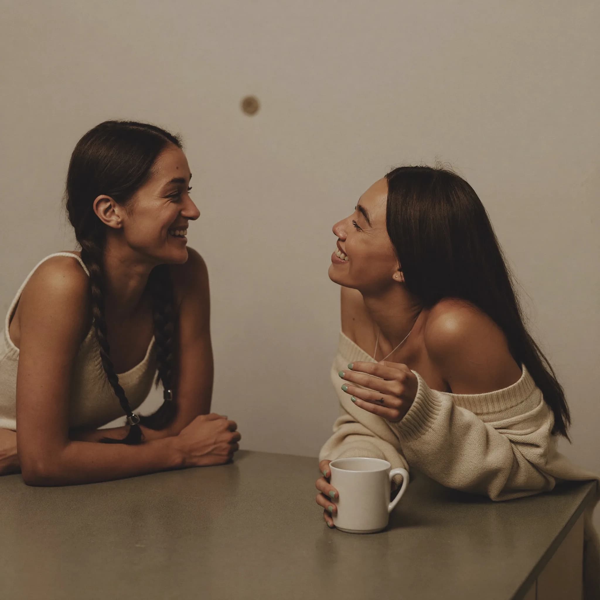 A volunteer welcoming a woman into a community session